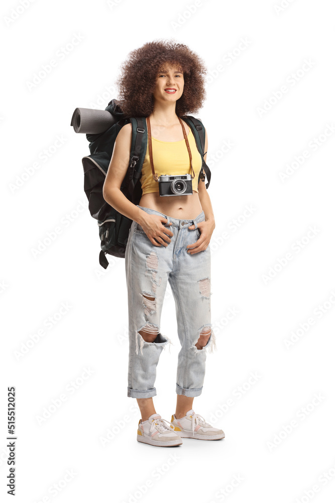 Happy young female traveler with a backpack and camera Happy young female traveler with a backpack and camera