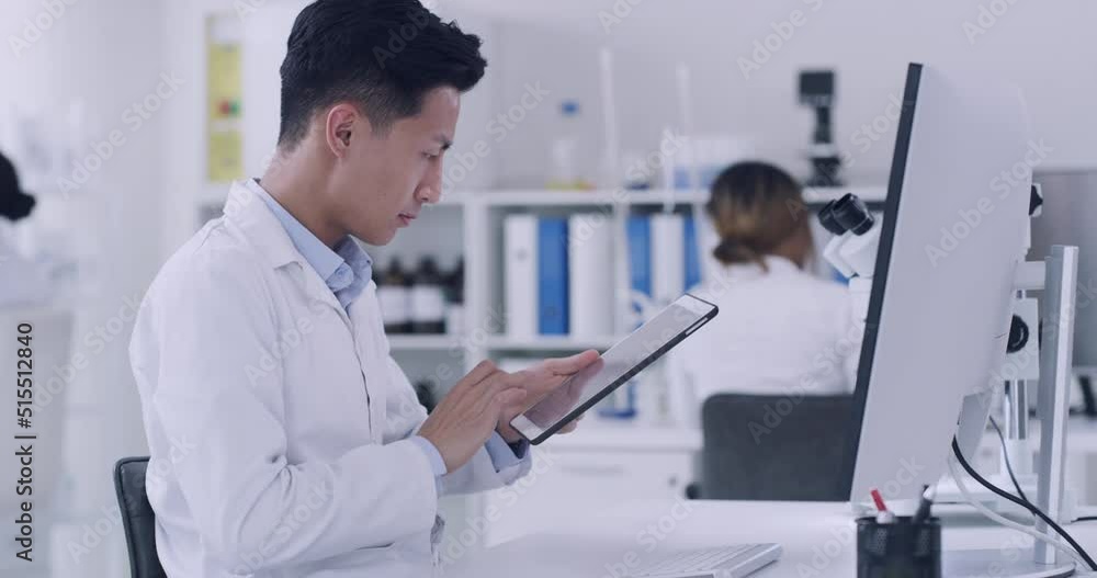 Pathologist, biochemist and genetic engineer using technology to record test results. Scientist using digital tablet and computer to research monkeypox virus while working on a cure in a laboratory.