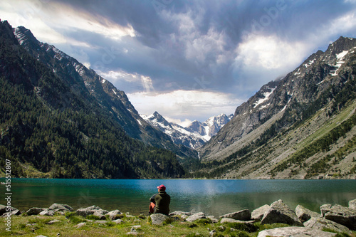 A young traveler in front of the rocks on the shore of Gaube Lake in the French Pyrenees. © Michael