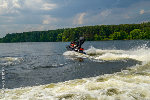 A man on a jet ski on the Klyazma or Pirogovsky reservoir in amazing summer in Moscow Oblast