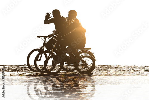 positive family rides bicycles on beach