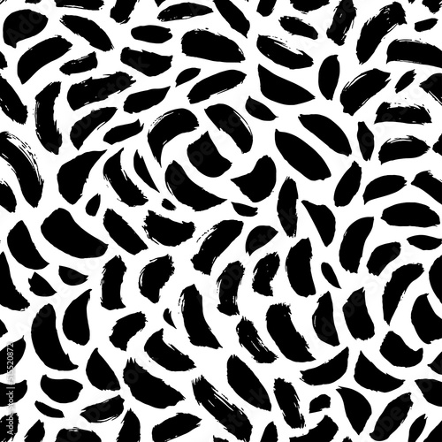 Abstract pattern of bold black shabby dots or spots on white background. Speckles of different size texture. Chaotic ink brush scribbles decorative texture. Monochrome hand drawn ornament.