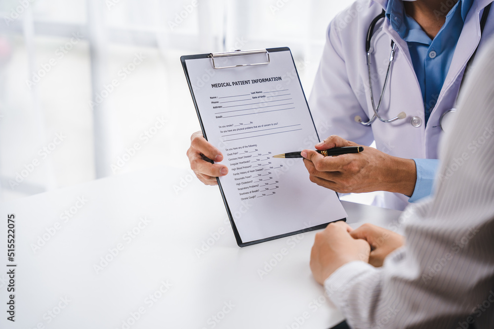 Doctor sitting at desk and writing a prescription for patient history. Doctor sitting at desk and writing a prescription for patient history.