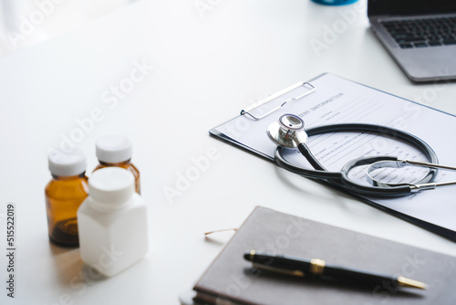 Close up laptop on white desk in empty cabinet with medical instruments at healthcare clinic. Nobody in doctors office with tools on table for professional specialists