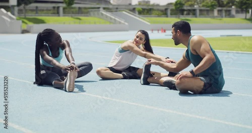 Diverse group of marathon runners talking while getting ready for a race in a stadium. Young athletes stretching their legs as a warmup exercise to prevent injury during training on a sports track.