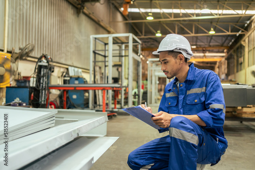 Canvas-taulu Asian attractive man industrial worker working in manufacturing plant