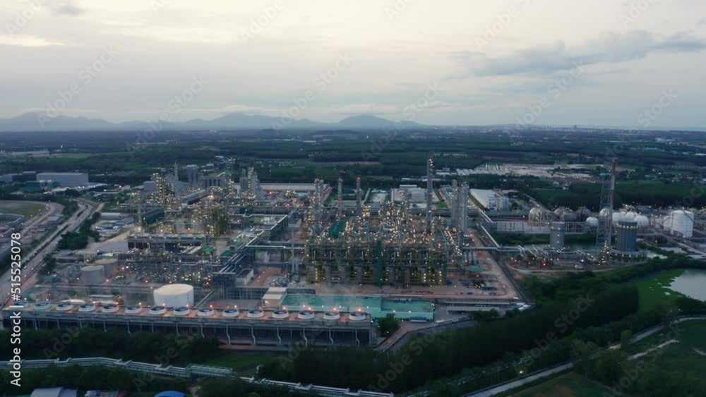 Aerial view drone flying with light oil terminal is industrial facility for storage of oil and petrochemical. oil manufacturing products. power electric plant. low light. Refinery b roll drone shot 4k Aerial view drone flying with light oil terminal is industrial facility for storage of oil and petrochemical. oil manufacturing products. power electric plant. low light. Refinery b roll drone shot 4k