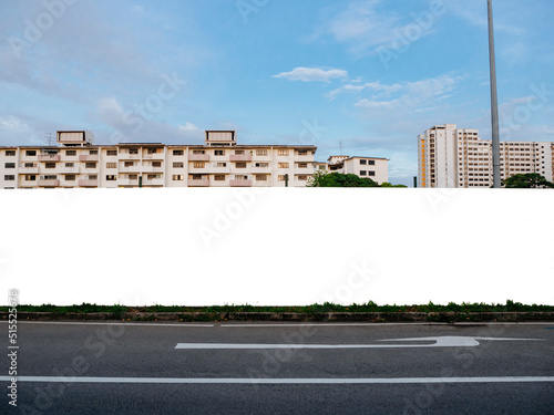 Blank template mock-up of a fenced up construction hoarding in front of housing apartment flats. Empty outdoor advertising space for commercial or real estate properties in a residential neighbourhood