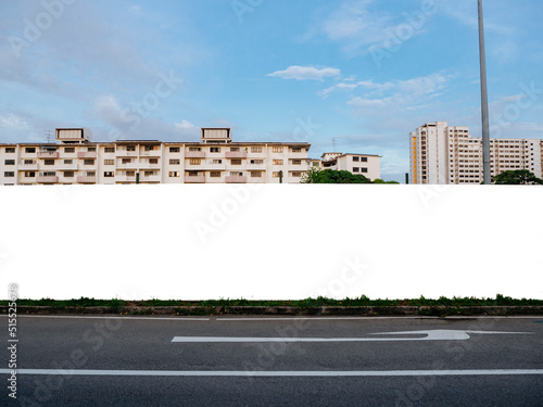 Blank template mock-up of a fenced up construction hoarding in front of housing apartment flats. Empty outdoor advertising space for commercial or real estate properties in a residential neighbourhood photo