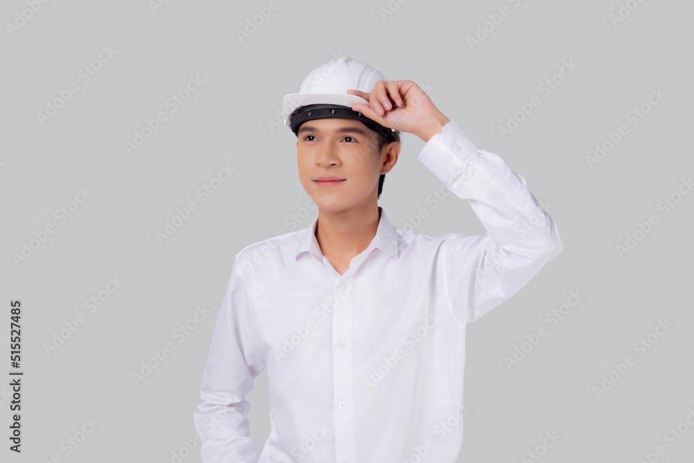 Portrait young asian man is engineer wearing helmet standing and smiling with confident isolated on white background, handsome male is architect or contractor, worker or labor, industrial concept. Portrait young asian man is engineer wearing helmet standing and smiling with confident isolated on white background, handsome male is architect or contractor, worker or labor, industrial concept.