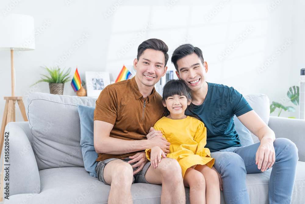 Portrait of Asian LGBTQ gay loving family sit on sofa with girl kid. Portrait of Asian LGBTQ gay loving family sit on sofa with girl kid.