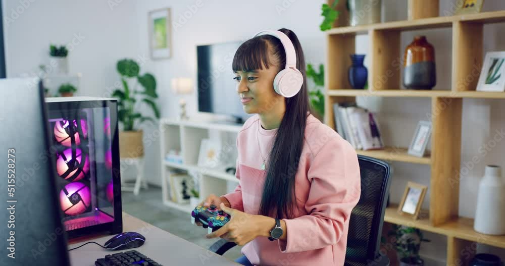 Young female gamer playing video game console with a headset. Trendy woman with headset and latest tech practicing her gaming skills on an online gaming system, determined to win a challenging level Young female gamer playing video game console with a headset. Trendy woman with headset and latest tech practicing her gaming skills on an online gaming system, determined to win a challenging level