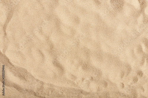 Fototapeta Naklejka Na Ścianę i Meble -  Natural texture: top view of beach sand, clear, clean and smooth. Minimalist background for summer concepts, travel, vacations and outdoor enjoyment.