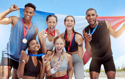 Happy and proud French olympic athletes celebrating winning medals for their country. Portrait of a diverse group of sports people with a French flag, cheering and proud of their success and victory