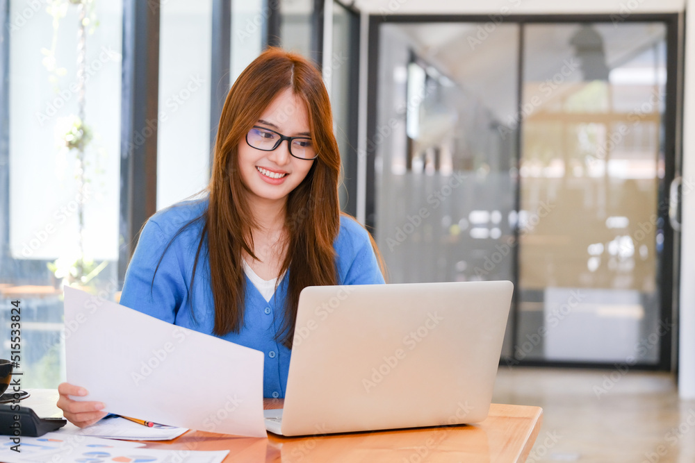 A female college student uses a computer to access the Internet for online learning. A female college student uses a computer to access the Internet for online learning.