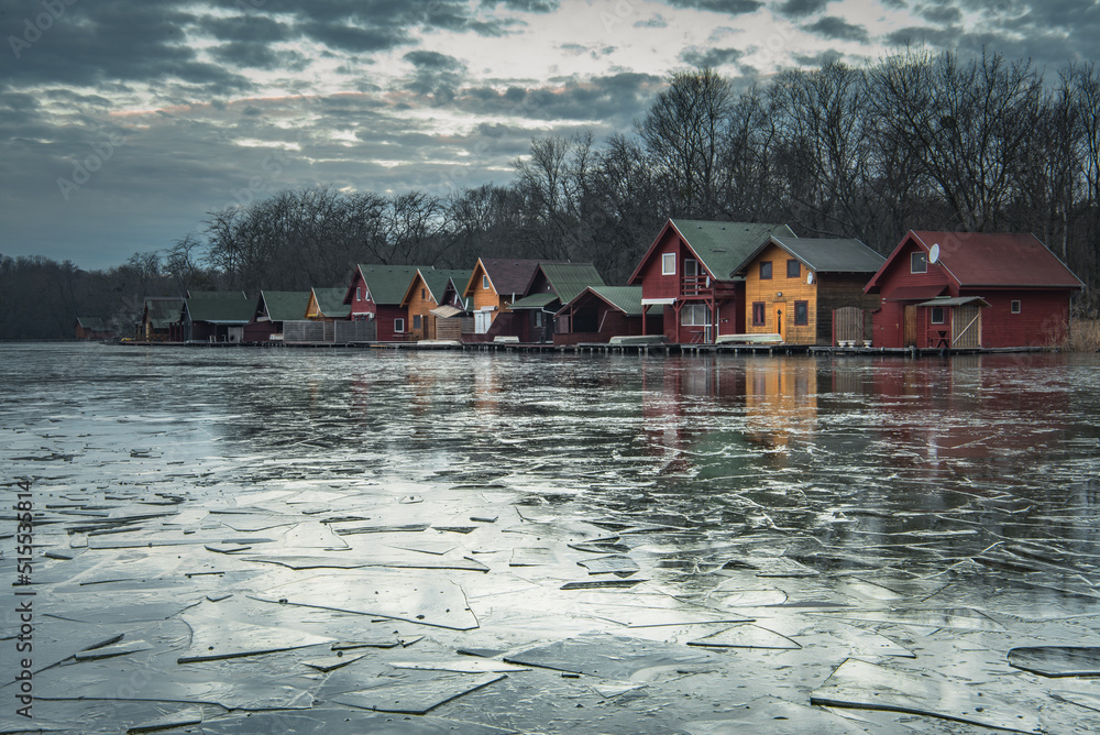 Fototapeta premium Dawn landscape of colorful houses at the lake 