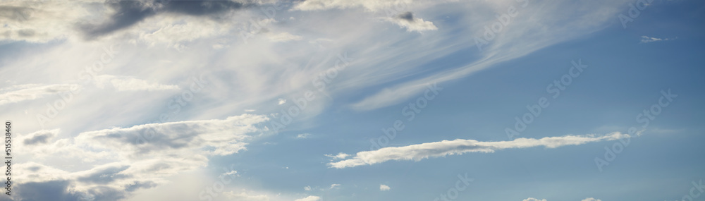 Light clouds in a calm blue sky with copy space background. A beautiful clear summer sky with sunshine and a white soft textured cloudscape in nature. relaxing skies clearing up on a sunny day