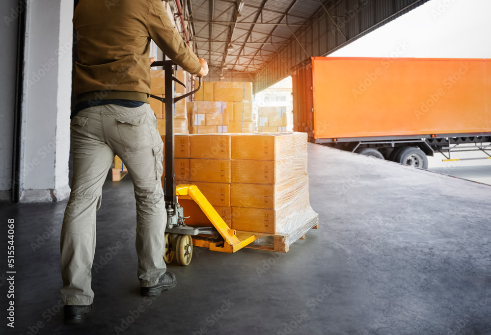 Workers Unloading Packaging Boxes on Pallets into The Cargo Container Trucks. Loading Dock. Shipping Warehouse. Delivery. Shipment Goods. Supply Chain. Warehouse Logistics Cargo Transport. Workers Unloading Packaging Boxes on Pallets into The Cargo Container Trucks. Loading Dock. Shipping Warehouse. Delivery. Shipment Goods. Supply Chain. Warehouse Logistics Cargo Transport.