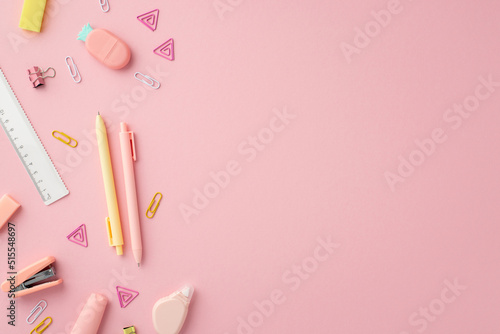 School supplies concept. Top view photo of stationery pens ruler stapler binder clips round correction tape and pineapple shaped eraser on isolated pink background with copyspace