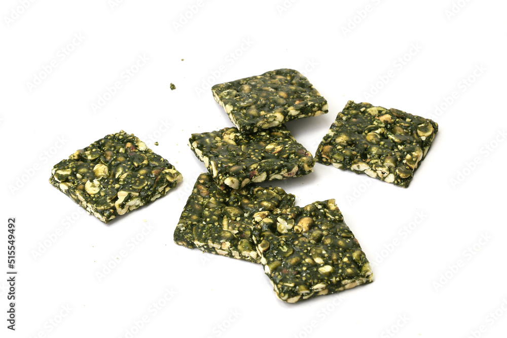Spirulina Chikki with groundnut and Jaggery isolated on white