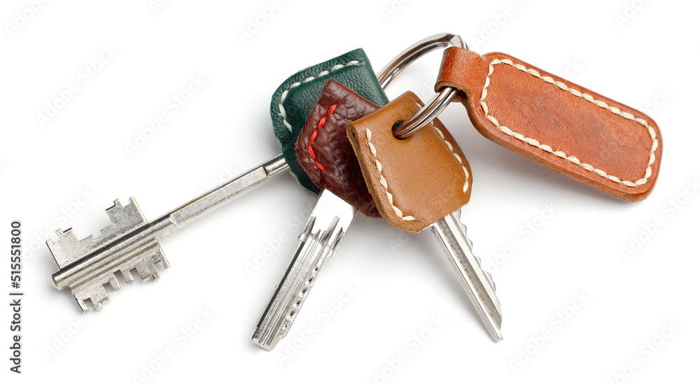 Keys in leather cases with an empty keychain isolated on white background. Keys in leather cases with an empty keychain isolated on white background.