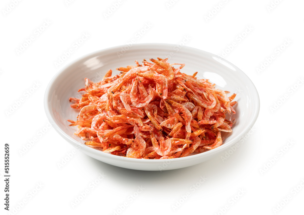 Dried sakura shrimps on a plate placed on a white background. Dried sakura shrimps on a plate placed on a white background.