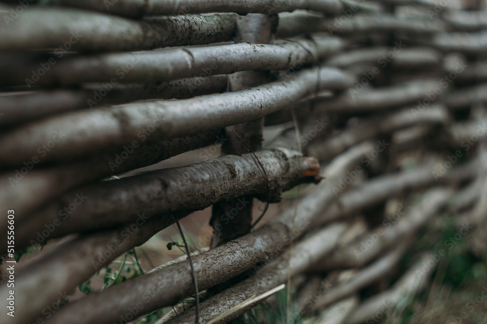 horizontal wicker wooden fence in the garden. Decoration, garden decor horizontal wicker wooden fence in the garden. Decoration, garden decor