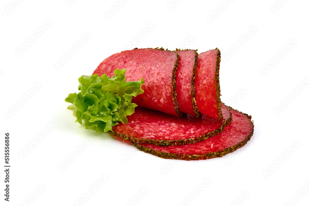 Cold smoked sausage slices covered with herbs and spices, isolated on white background. Cold smoked sausage slices covered with herbs and spices, isolated on white background.