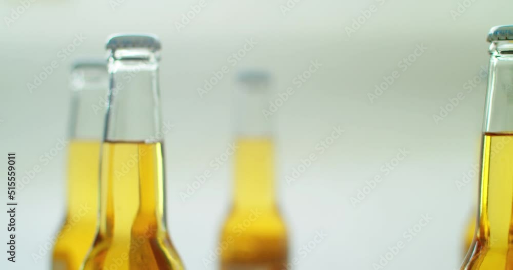 Process of bottling beverages on drinks production beer, beer in glass bottles on automatic conveyor line. Manufacturing of Alcoholic drinks. Process of bottling beverages on drinks production beer, beer in glass bottles on automatic conveyor line. Manufacturing of Alcoholic drinks.