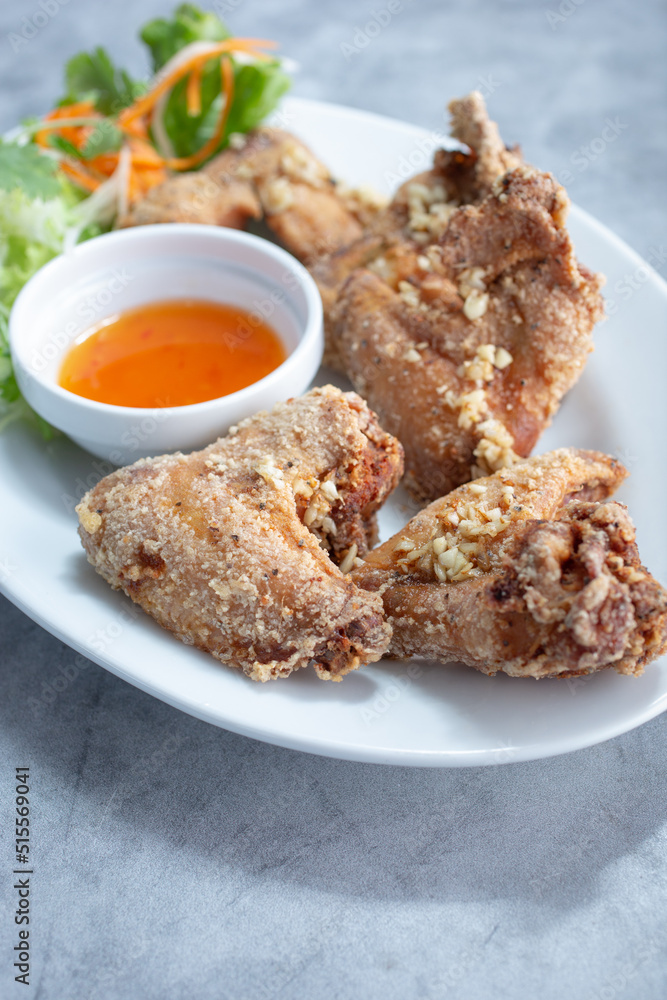 A view of a plate of Asian chicken wings.
