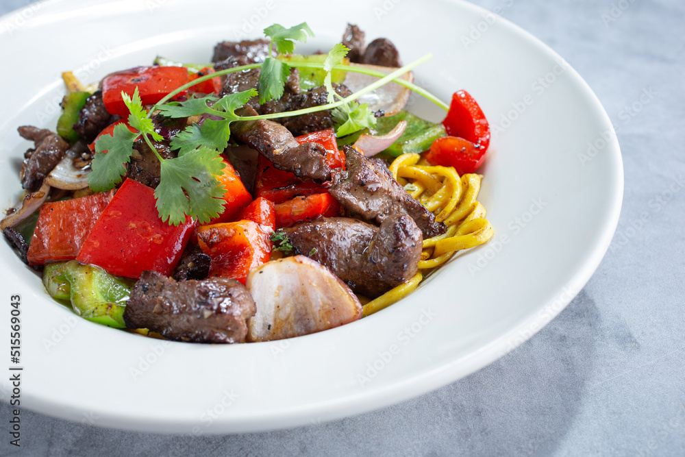A view of a plate of shaken beef. A view of a plate of shaken beef.