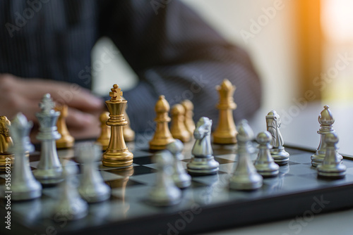 Businessman moving chess pieces on chess board game ideas for ideas and competitions and strategies, success, business competition planning ideas.