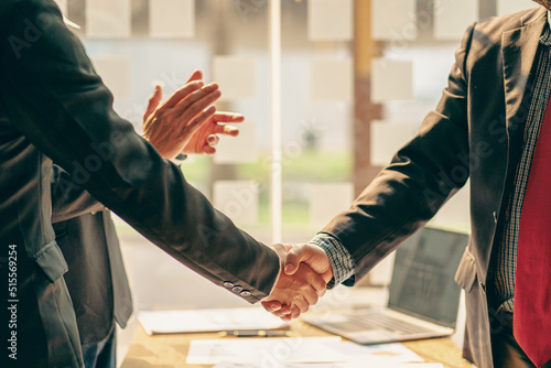 Close-up of business people shaking hands. End of meeting. Business etiquette. congratulations merger concept A businessman accepts or confirms a project as an offer and shakes hands at the office. photo