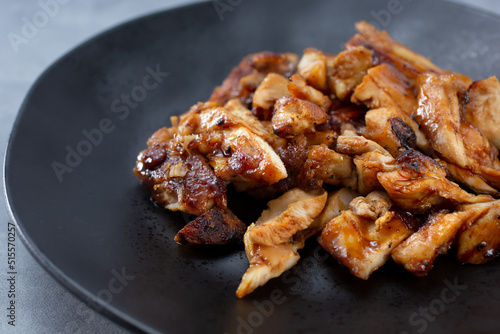 A closeup view of a plate of teriyaki chicken.