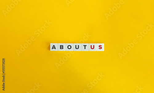 About Us Banner. Text on Letter Tiles on Yellow Background. Minimal Aesthetics.
