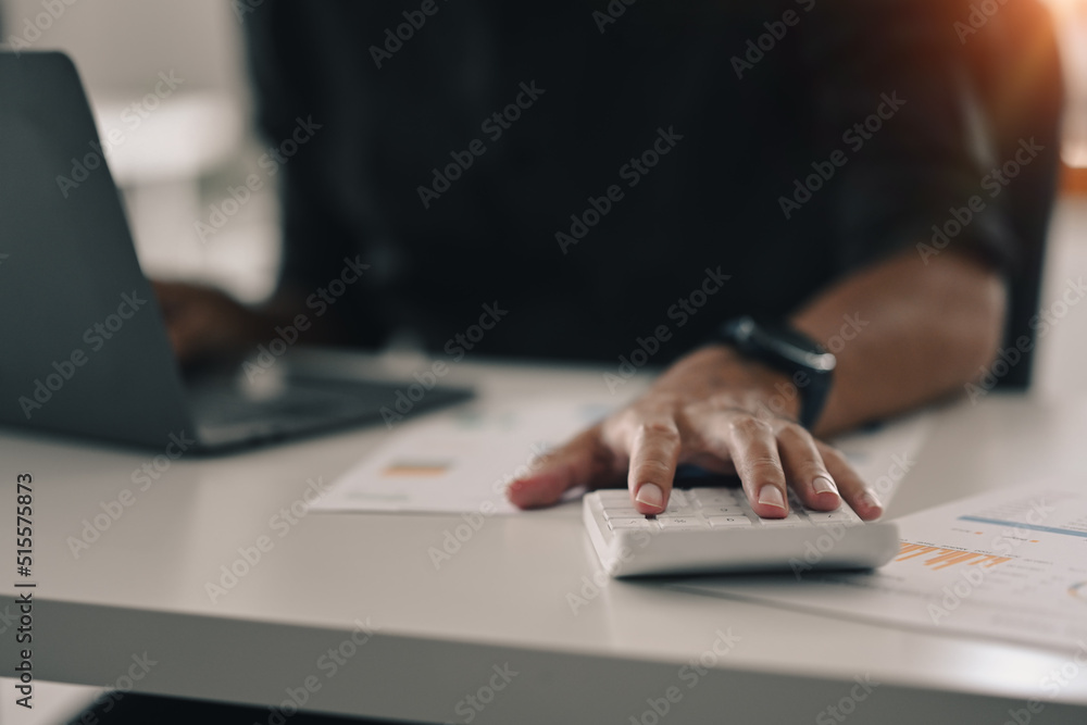 Cropped view of professional businessman using laptop and preparing annual financial report at office desk Cropped view of professional businessman using laptop and preparing annual financial report at office desk