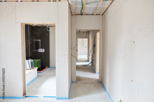 Wallpaper Mural House construction with door opening to the bathroom with fresh screed Torontodigital.ca