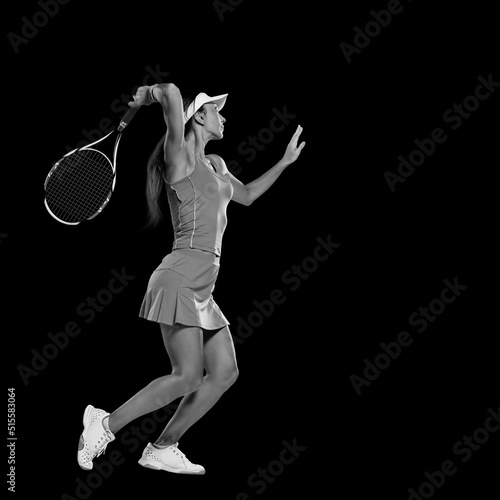 Female professional tennis player in action isolated on black background © Denys Kurbatov