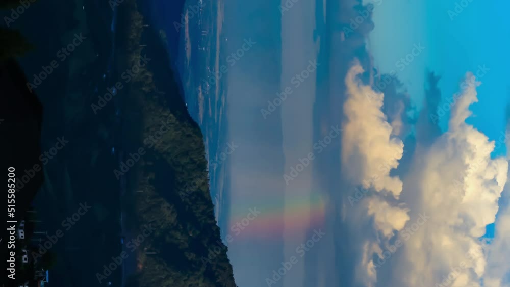 vertical Time-lapse of cloud with rain and rainbow over mountain at Khao Kho, Phetchabun, Thailand