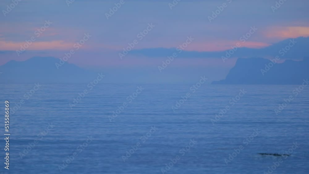 Mountains At The Sea Horizon During Sunset In Costa del Sol, Spain - wide Mountains At The Sea Horizon During Sunset In Costa del Sol, Spain - wide