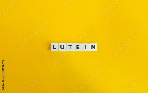 Lutein Word and Banner. Text on Letter Tiles on Yellow Background. Minimal Aesthetics. photo