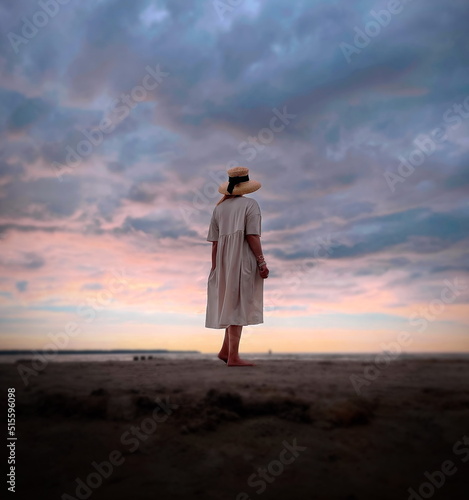 women stay on beach sand ,dark dramatic cloudy sunset sky , young girl watching to sea panorama wild nature landscape seascape summer romantic background weather forecast