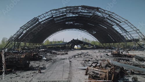 Wrecked Ukrainian world's largest cargo plane stands in a hangar next to a large amount of destroyed Russian equipment photo