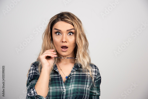 Portrait of shocked woman posing with stylish glasses