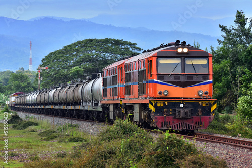 Tanker-freight train by diesel locomotive on the railway in Thailand.