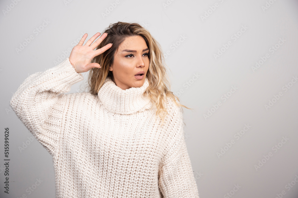 Beautiful woman in winter sweater showing her hand Beautiful woman in winter sweater showing her hand