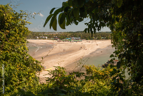 Ngwe Saung, Myanmar - November 23rd, 2019 : view from Lovers Island on the beach of Ngwe Saung on a sunny day with trees framing the view. photo