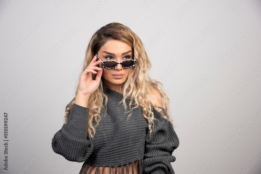 Young woman with eyeglasses looking at her side Young woman with eyeglasses looking at her side