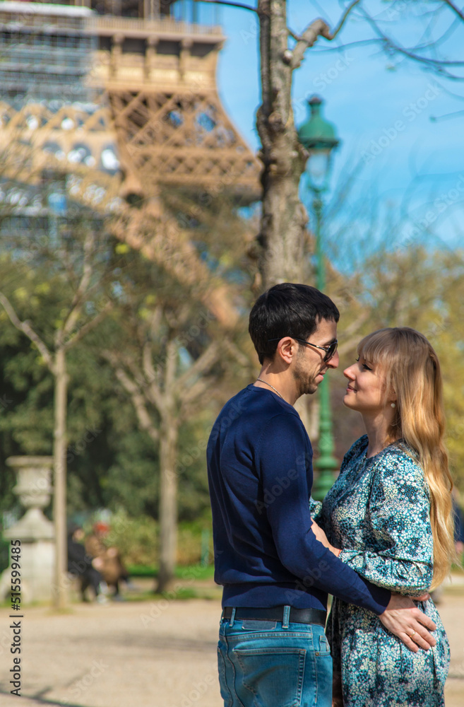 Couple man and woman near the eiffel tower. Selective focus. Couple man and woman near the eiffel tower. Selective focus.