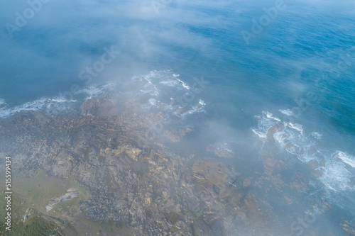 aerial view of rocky coastline on a foggy morning, Atlantic ocean